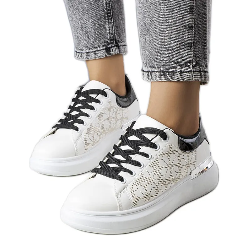 Black and white sneakers decorated with perforations from Erin