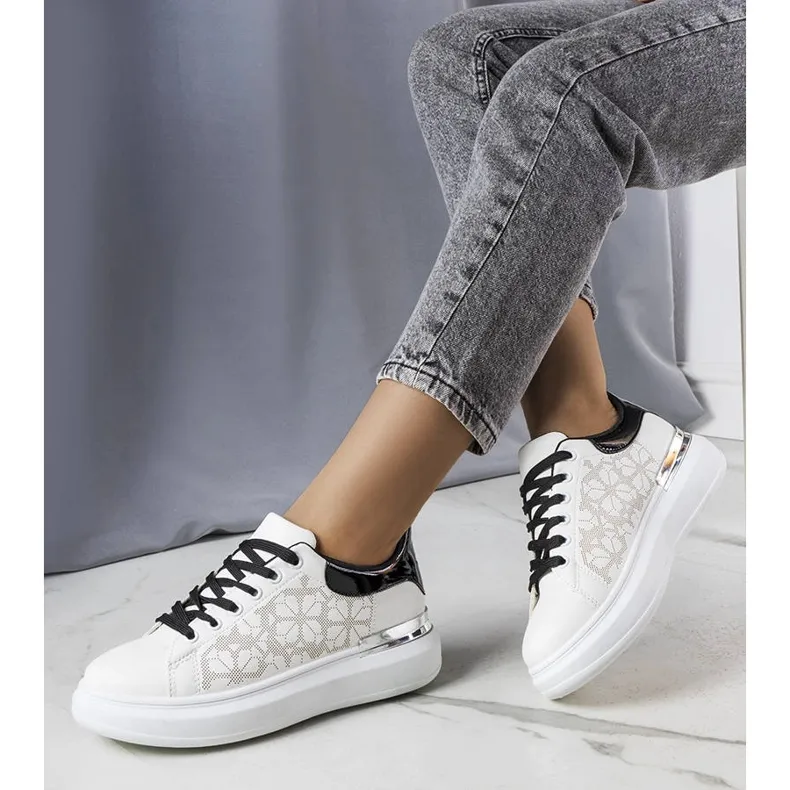 Black and white sneakers decorated with perforations from Erin