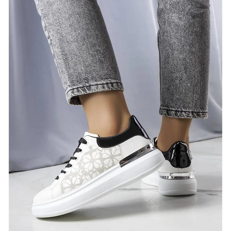 Black and white sneakers decorated with perforations from Erin